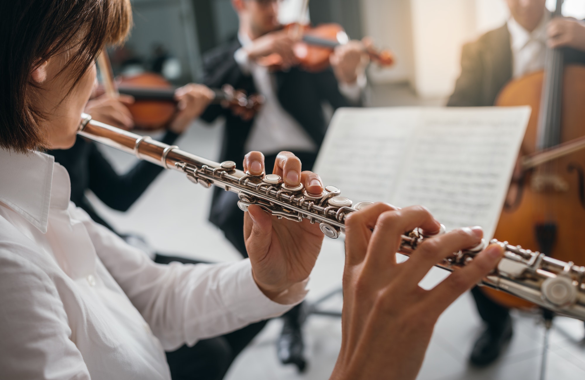 Flutist playing her instrument on stage